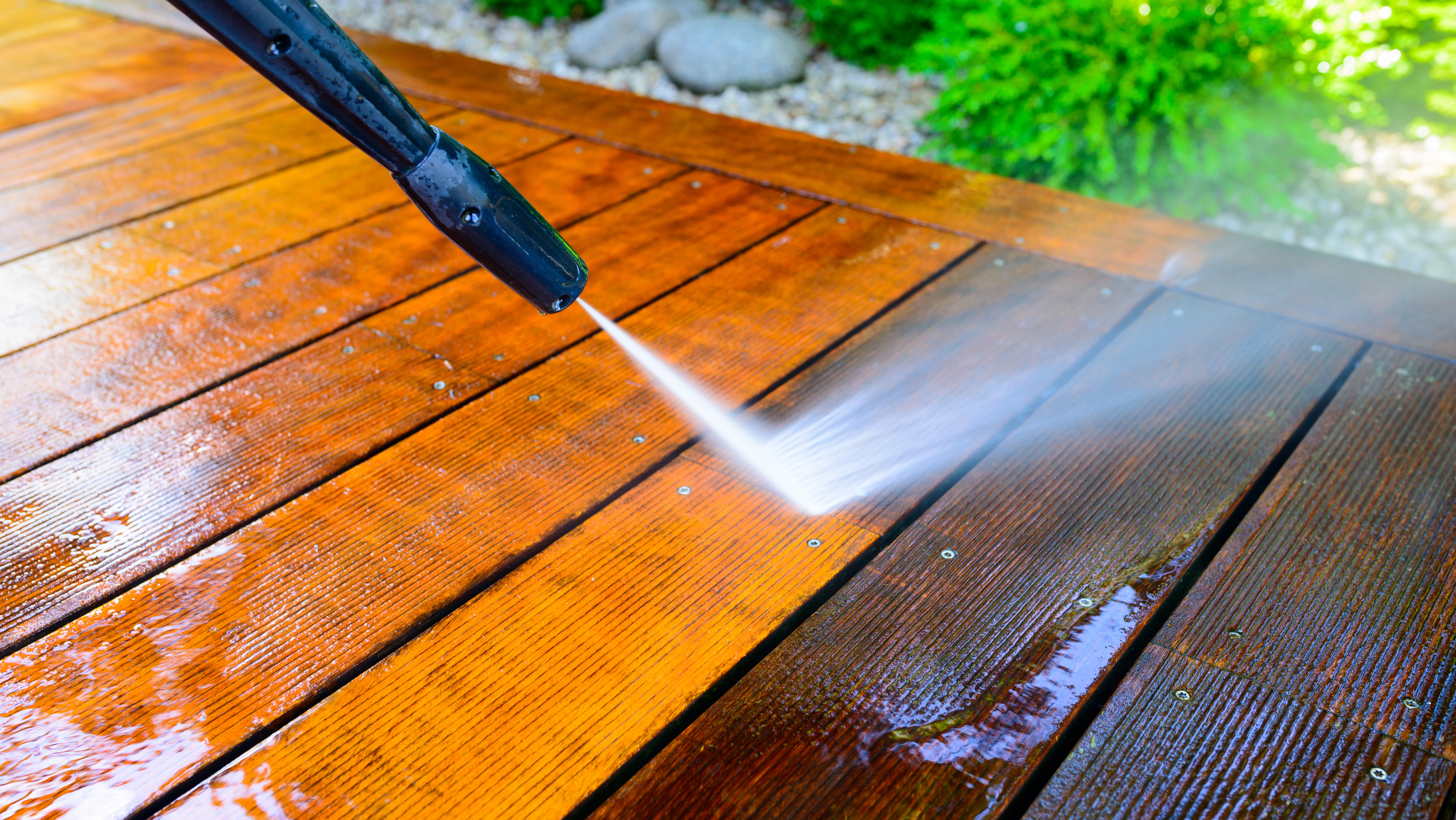 Close Up of Pressure Washer Cleaning Wooden Plates